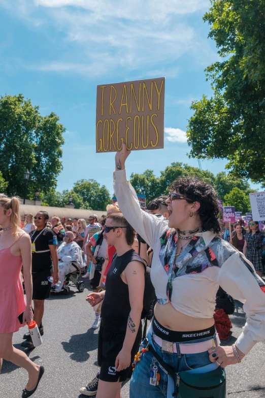 two people are standing in a crowd with signs that read, frankray unconscious