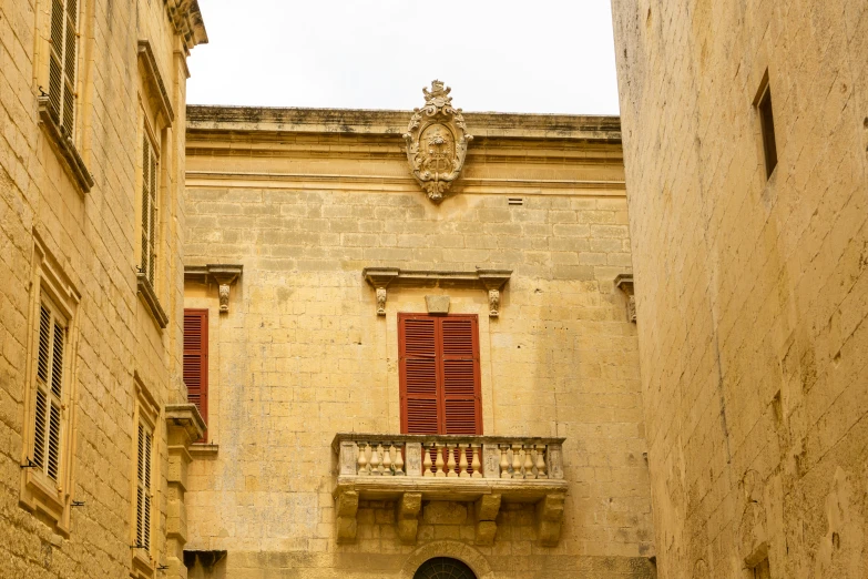 an open door into the courtyard area of a stone building