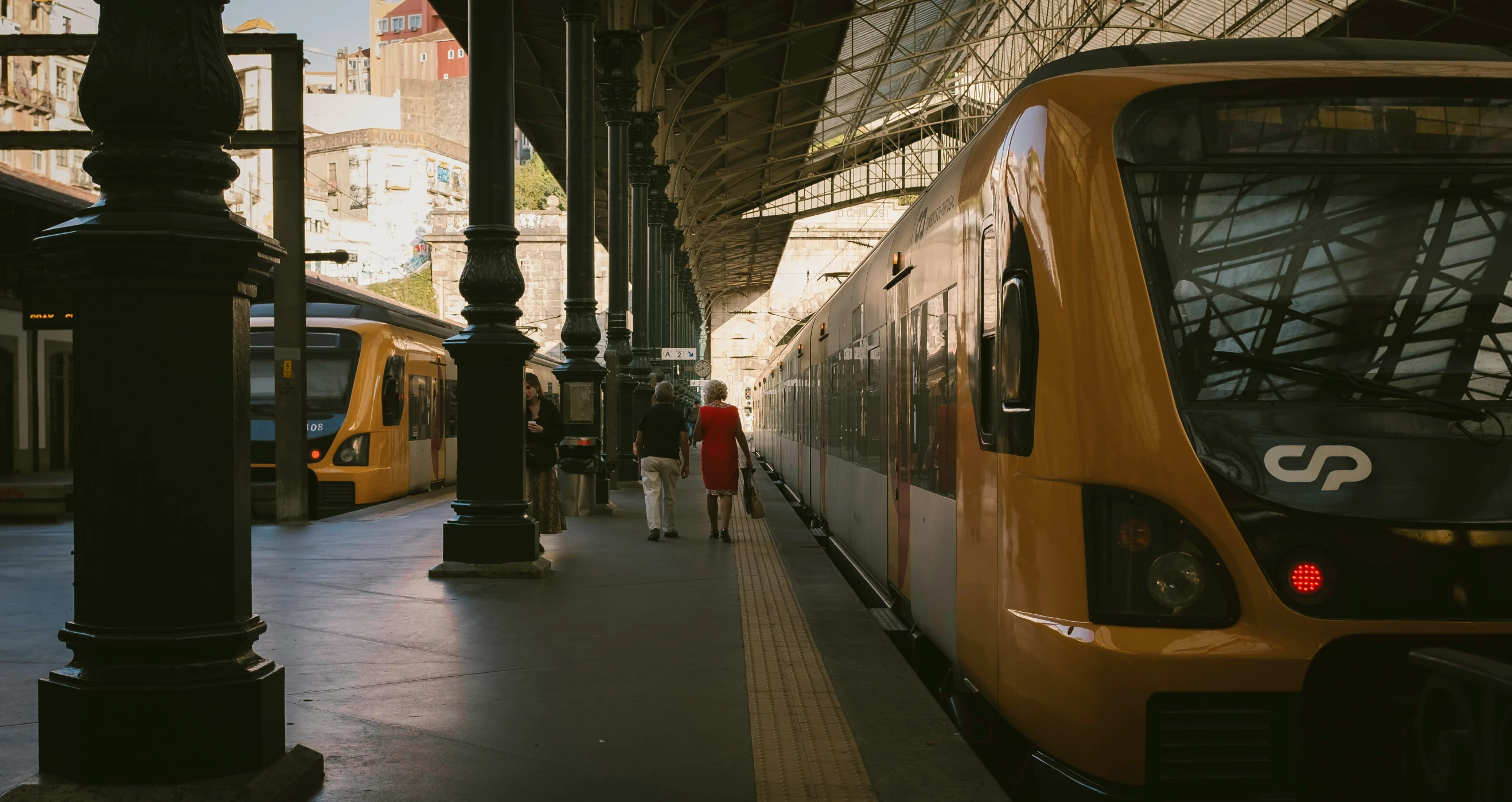 the people walk along the tracks near trains