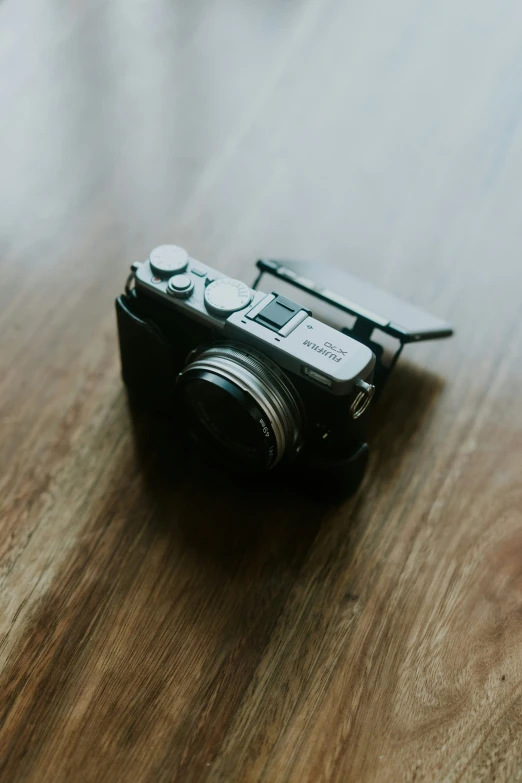 a close up of a camera on a wooden table