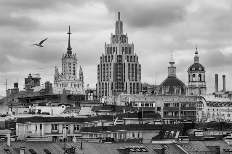 the skyline is full of tall buildings under a cloudy sky