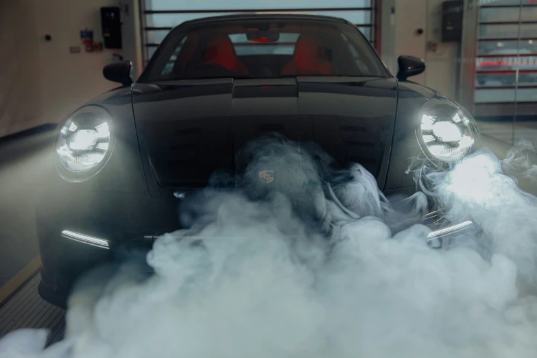 a car driving through a smoke filled room