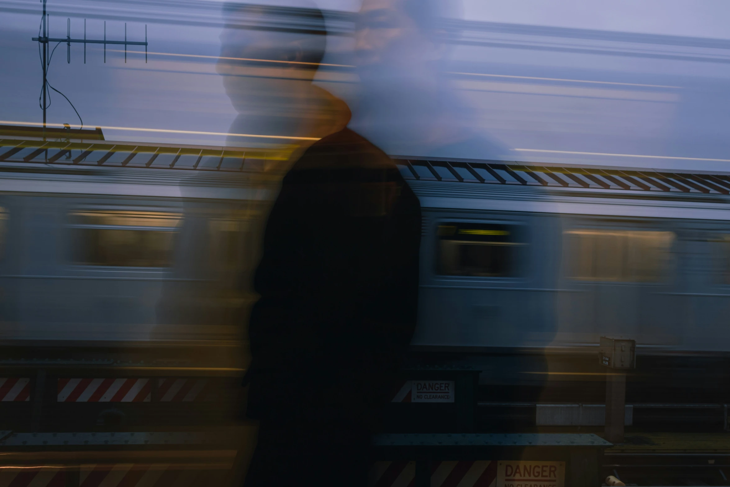 a blurry s of a man standing at a train station