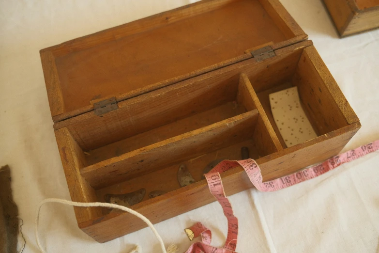 an old wooden box with a measuring tape