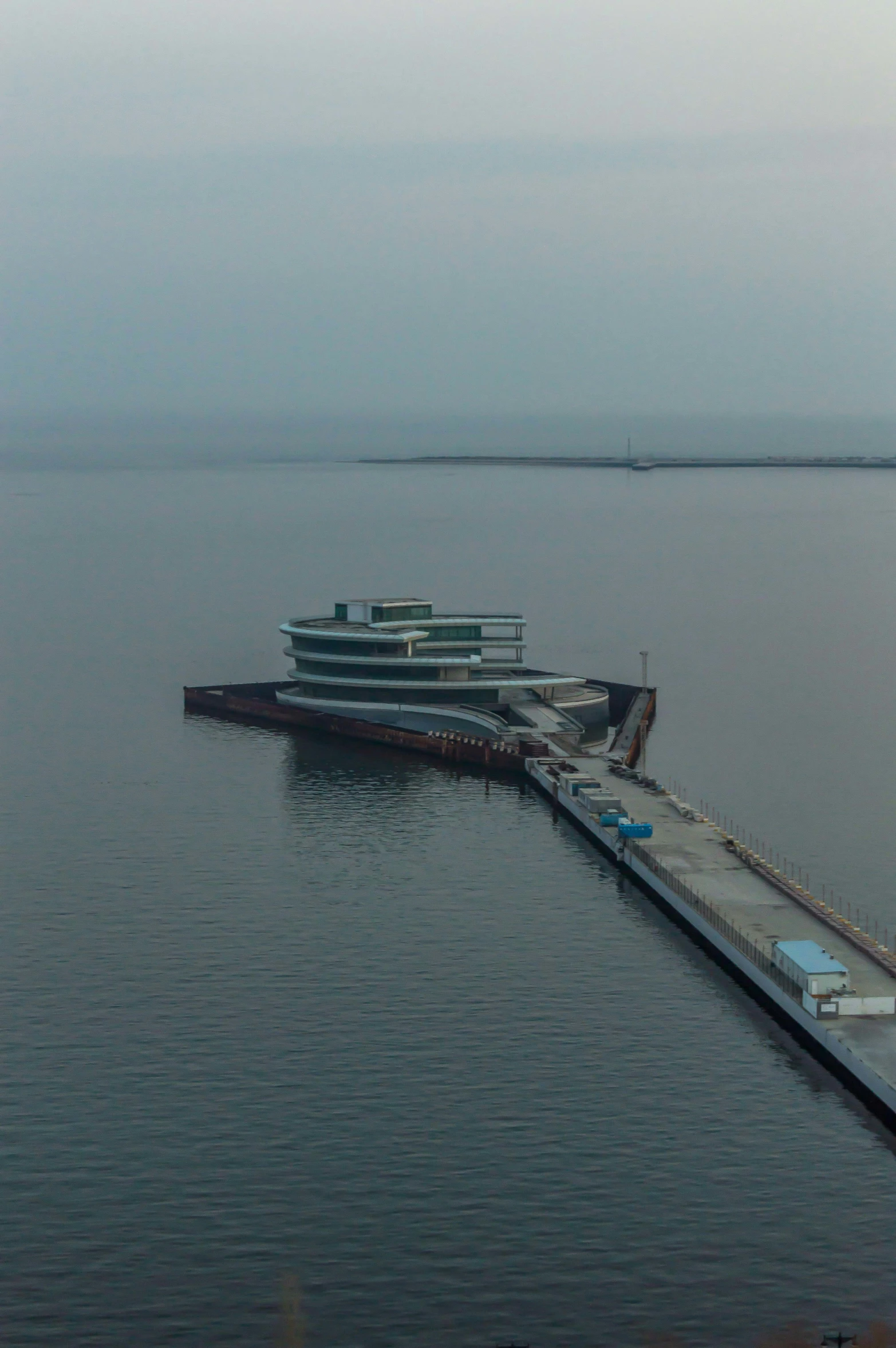 an empty pier with two large passenger ships docked