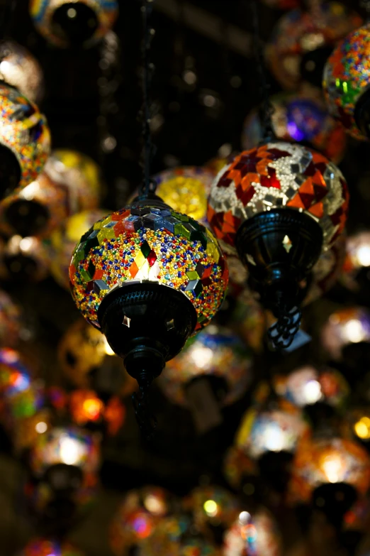 bright colored lamps hanging from the ceiling in a shop