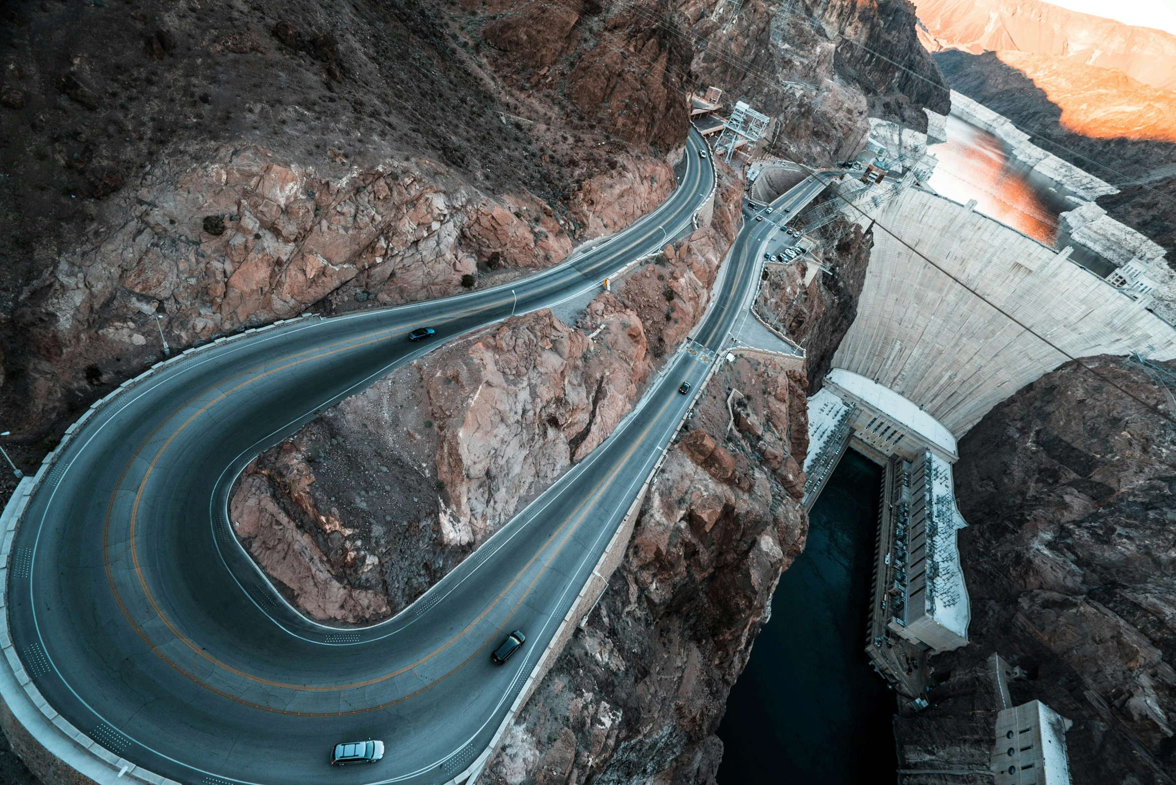 a winding highway crosses over a rock cliff