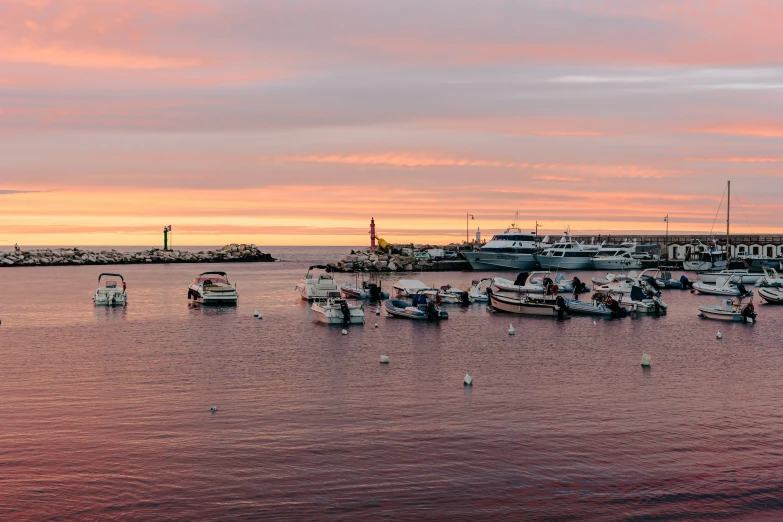 there are several small boats in the water