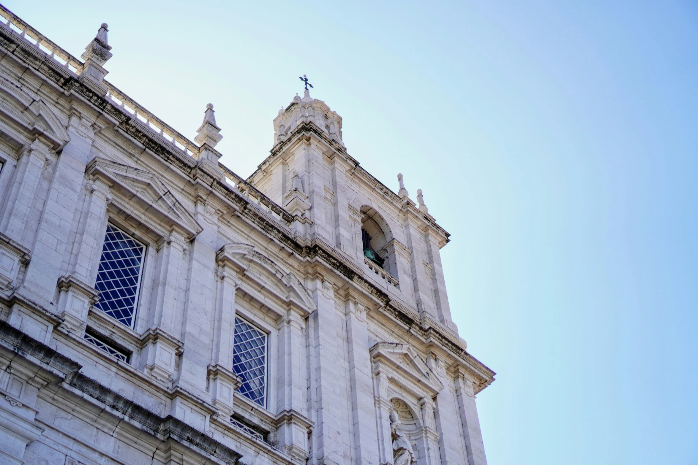 the top of an old church building with two steeples