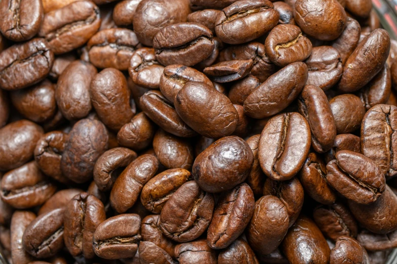 a bowl full of coffee beans that are almost raw