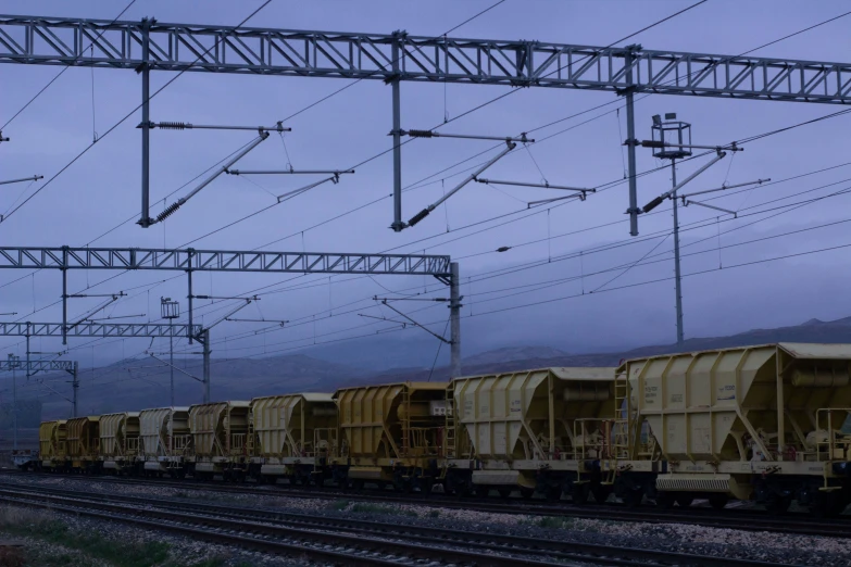 a couple of yellow train engines on a track