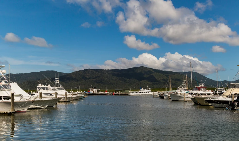 several boats that are docked near the shore