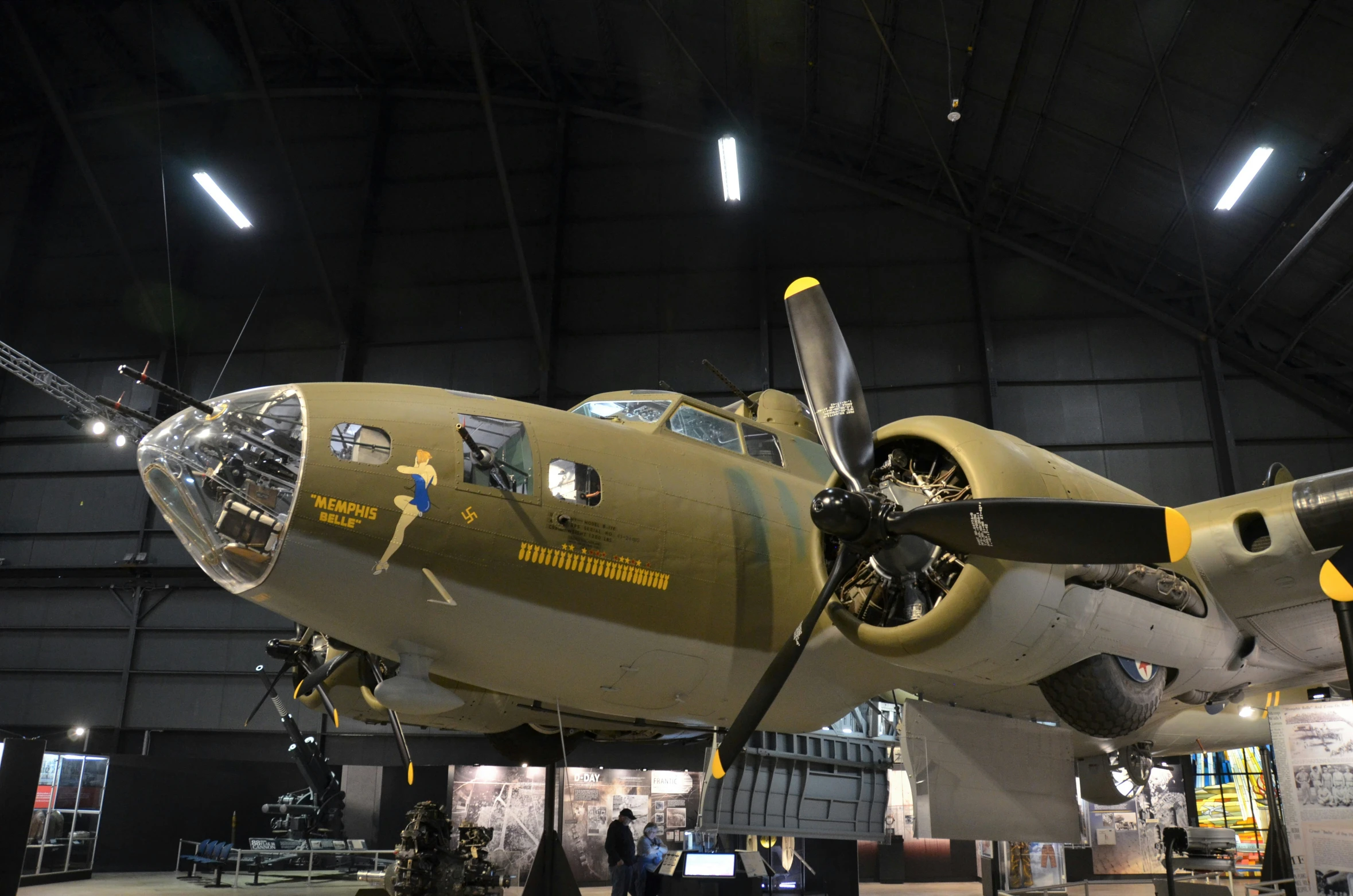 a yellow and white airplane is displayed at the museum