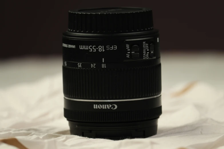 a close up view of a camera lens on a bed