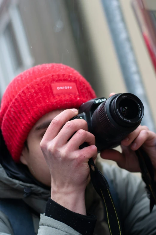 a man looking at the reflection in the mirror of his camera