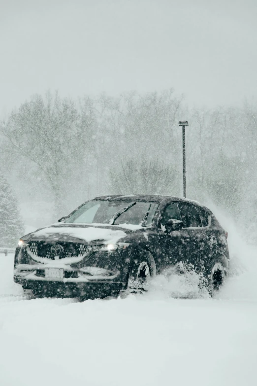 the vehicle is driving through a deep snow storm