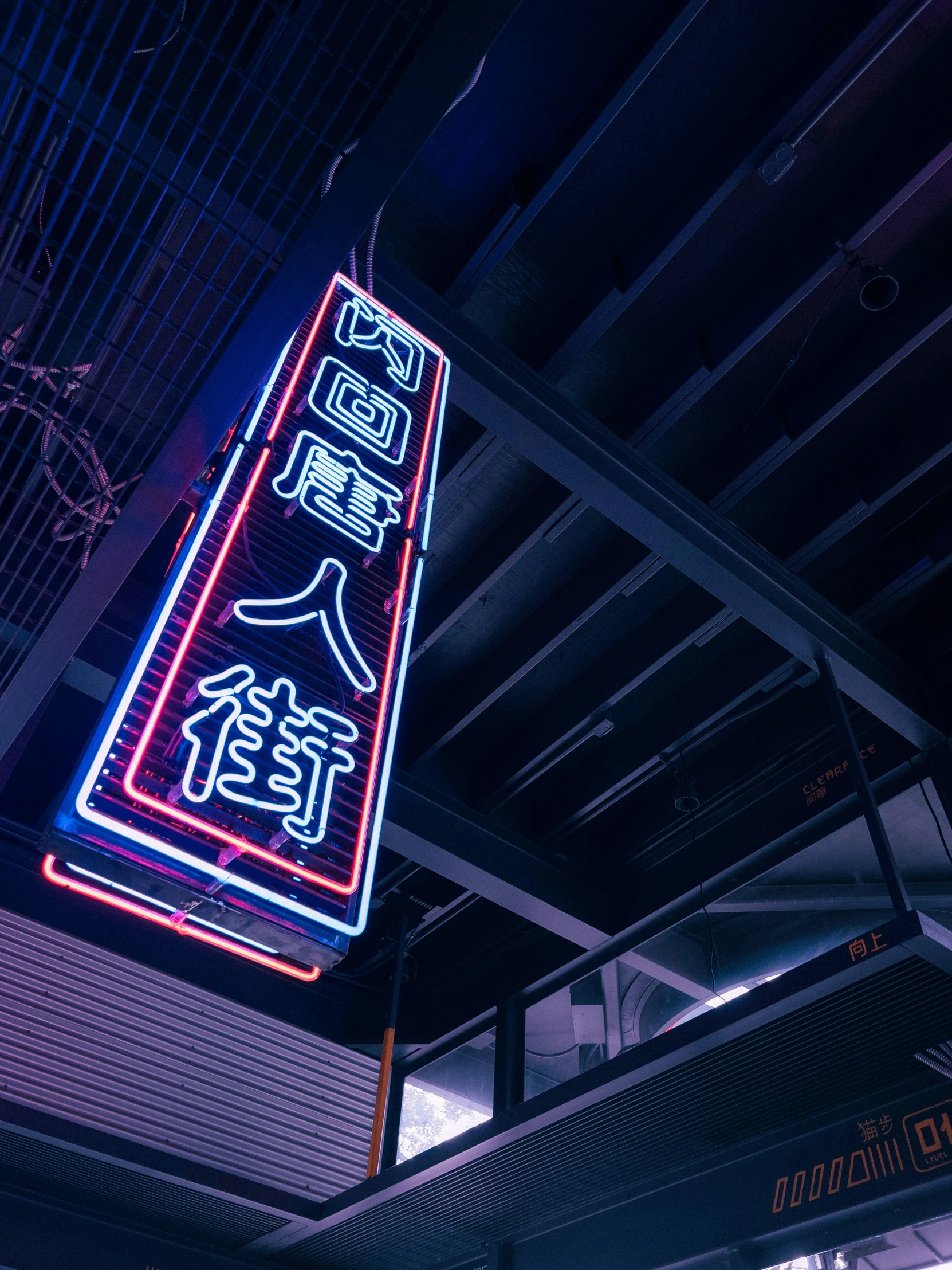 neon sign hanging from the ceiling of a building