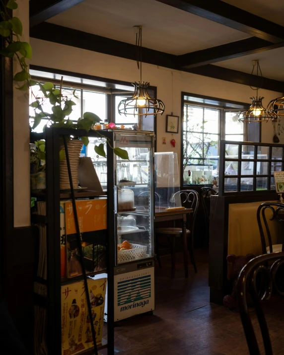 the inside of a restaurant with some plants