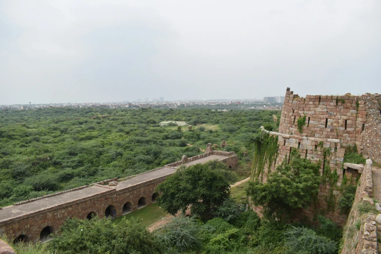 an overview of a stone structure with many trees in the background