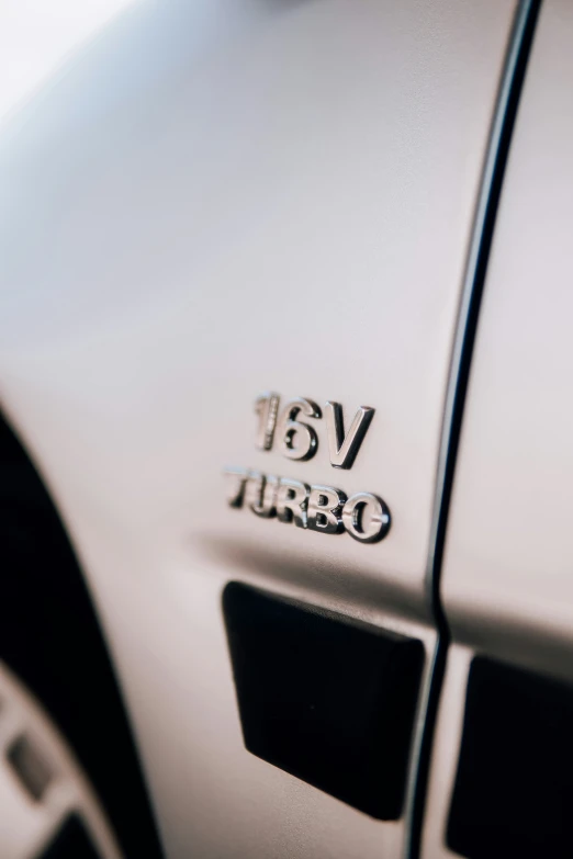 a close up s of the emblem on a white car