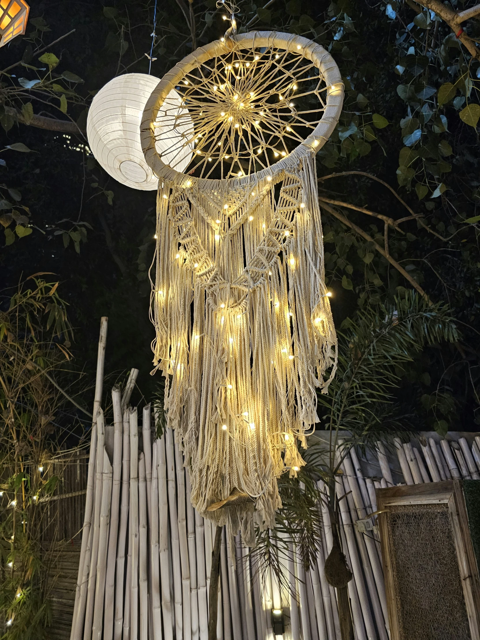 a decorative mobile in the middle of trees