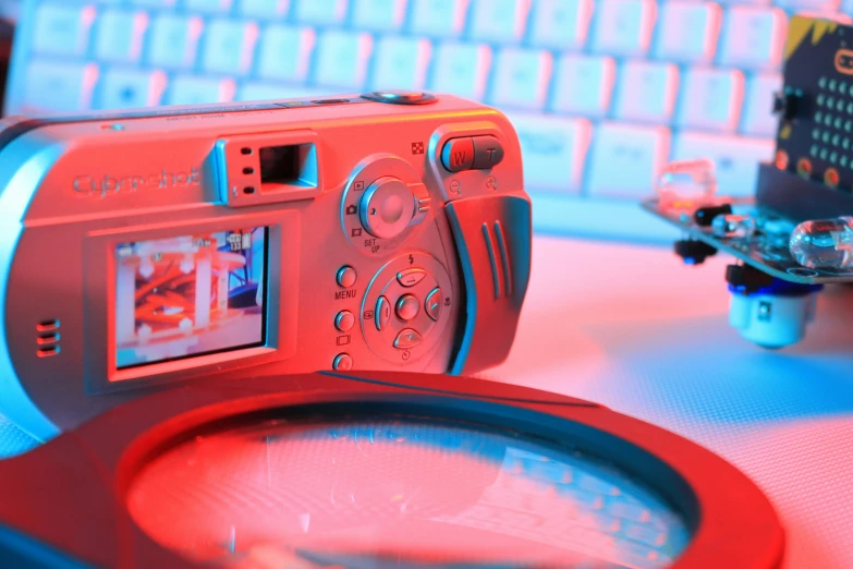 a camera sitting on top of a table next to a computer keyboard