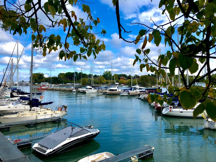 the boats are docked in the harbor with clear water