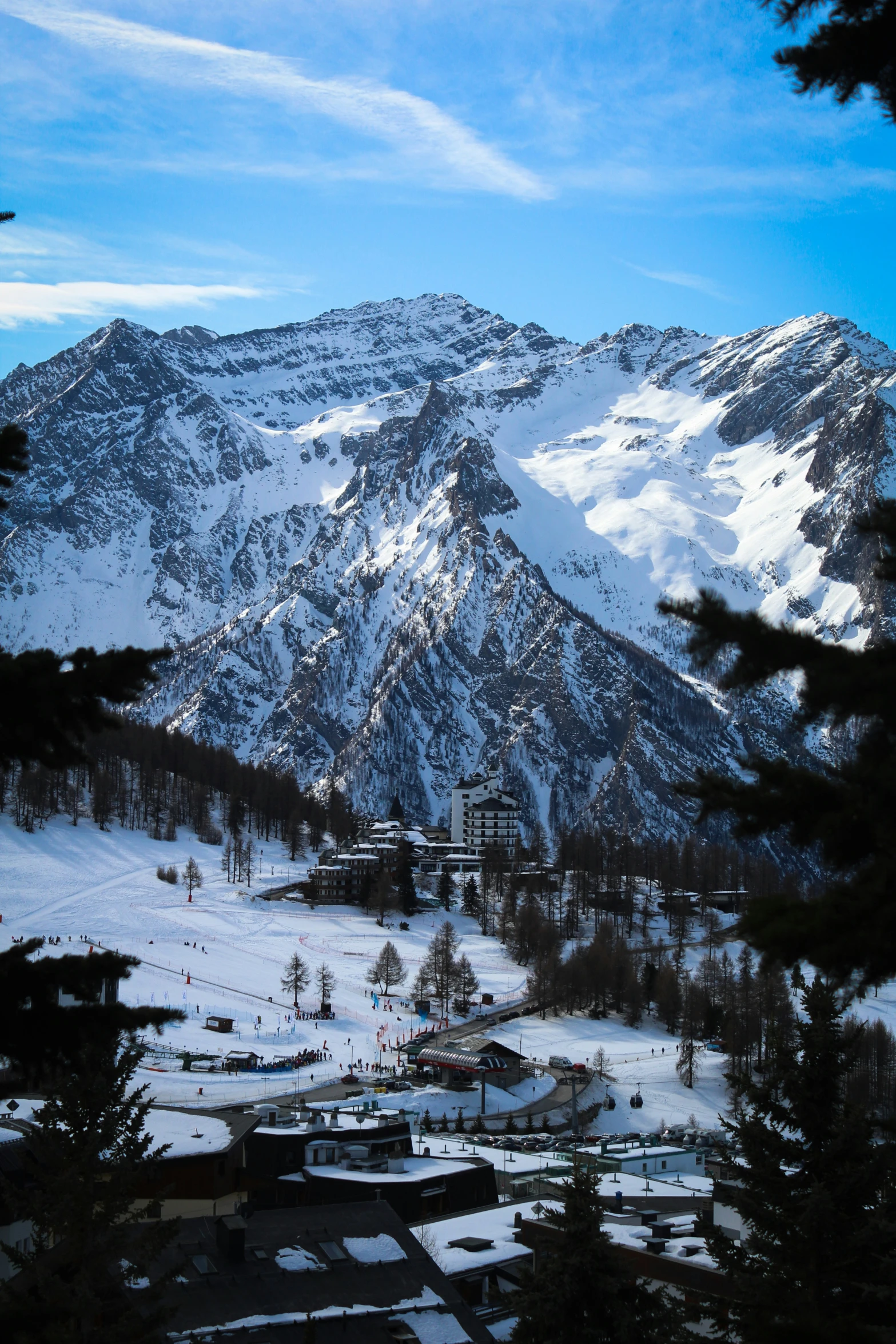 a mountain with a building on it and trees below