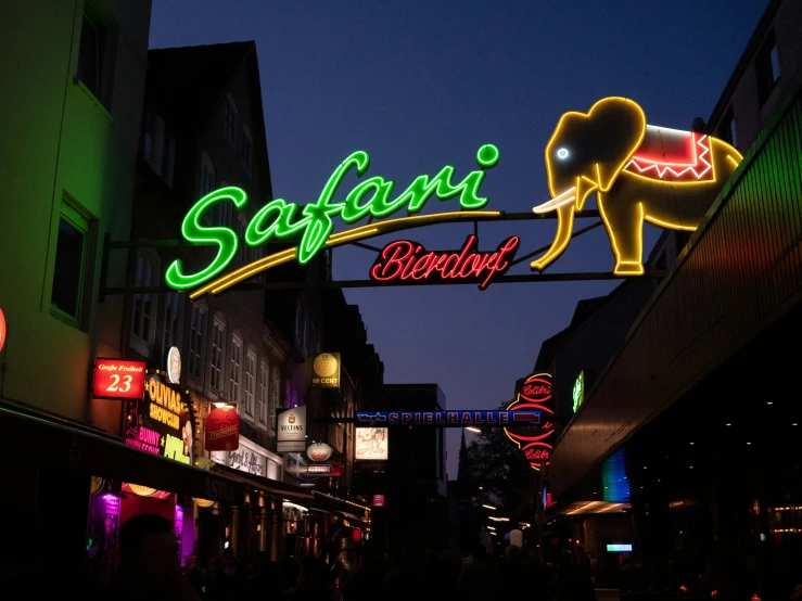 a city street at night lit up with neon