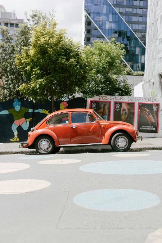 a orange beetle parked on the side of the road