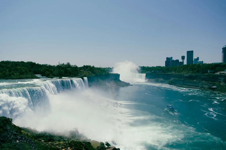 the boat rides through the large waterfall