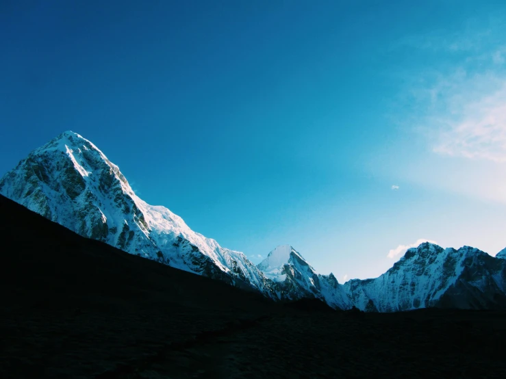 snowy mountains in the blue sky with a white peak