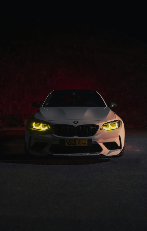 an illuminated car in the dark on the side of a road