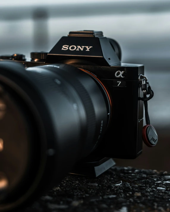 a sony camera sitting on the ground with its lens up