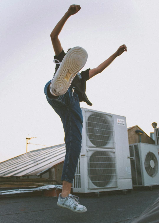 a person doing tricks on a skateboard with no shoes