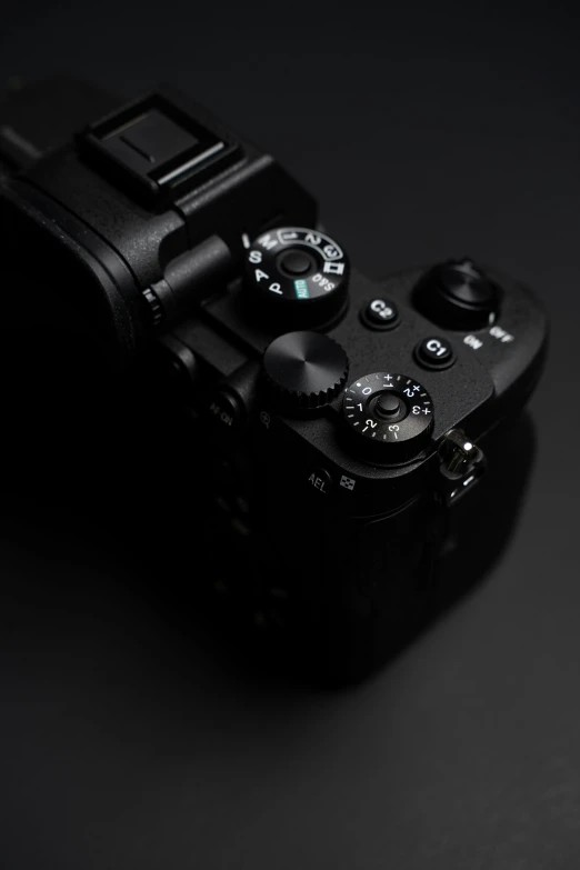 the black camera is set on the black surface