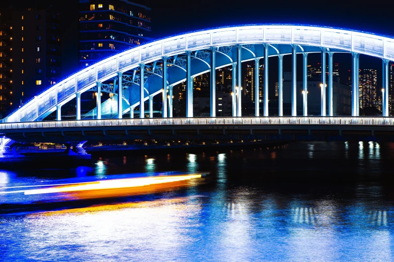 a boat that is in some water under a bridge