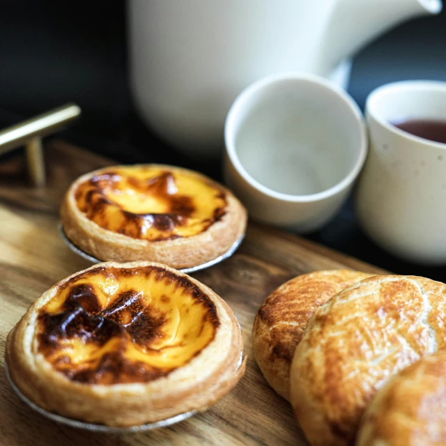 small pastries are lined up on a  board