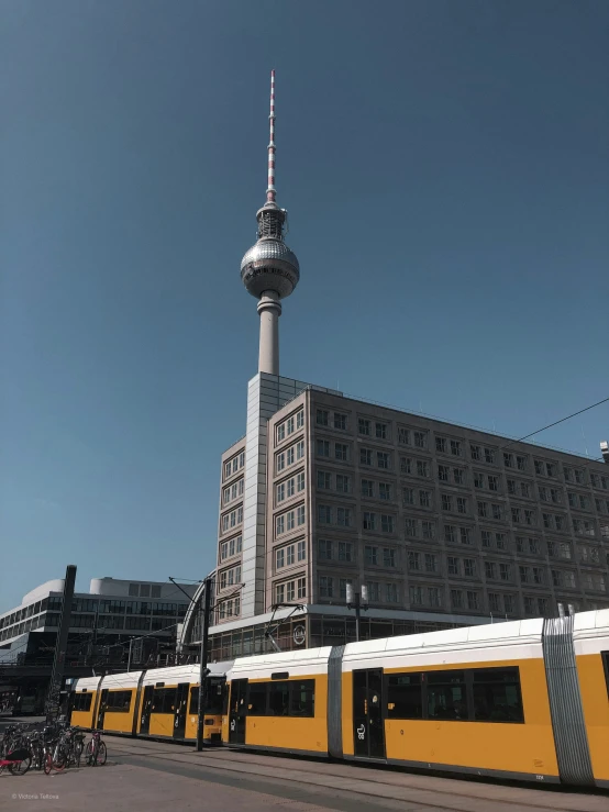 a train traveling past a large tall building