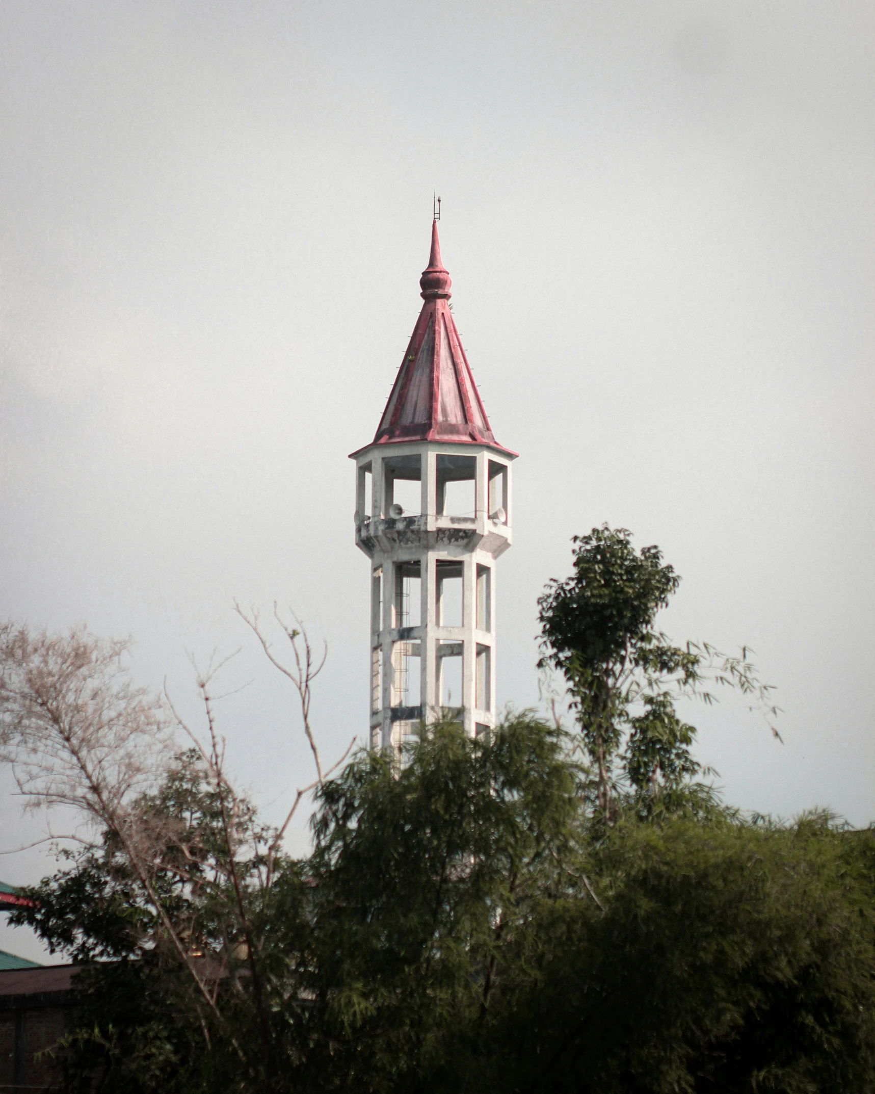 the tower on the top of a building has a metal roof