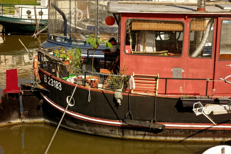 a red boat is parked at the dock