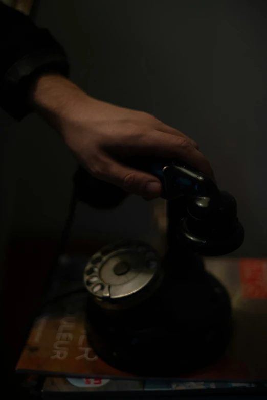 a person is pressing the on on an old fashioned telephone