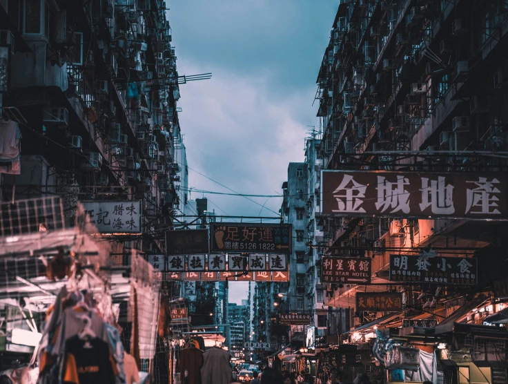 the people are walking down the busy street in the city