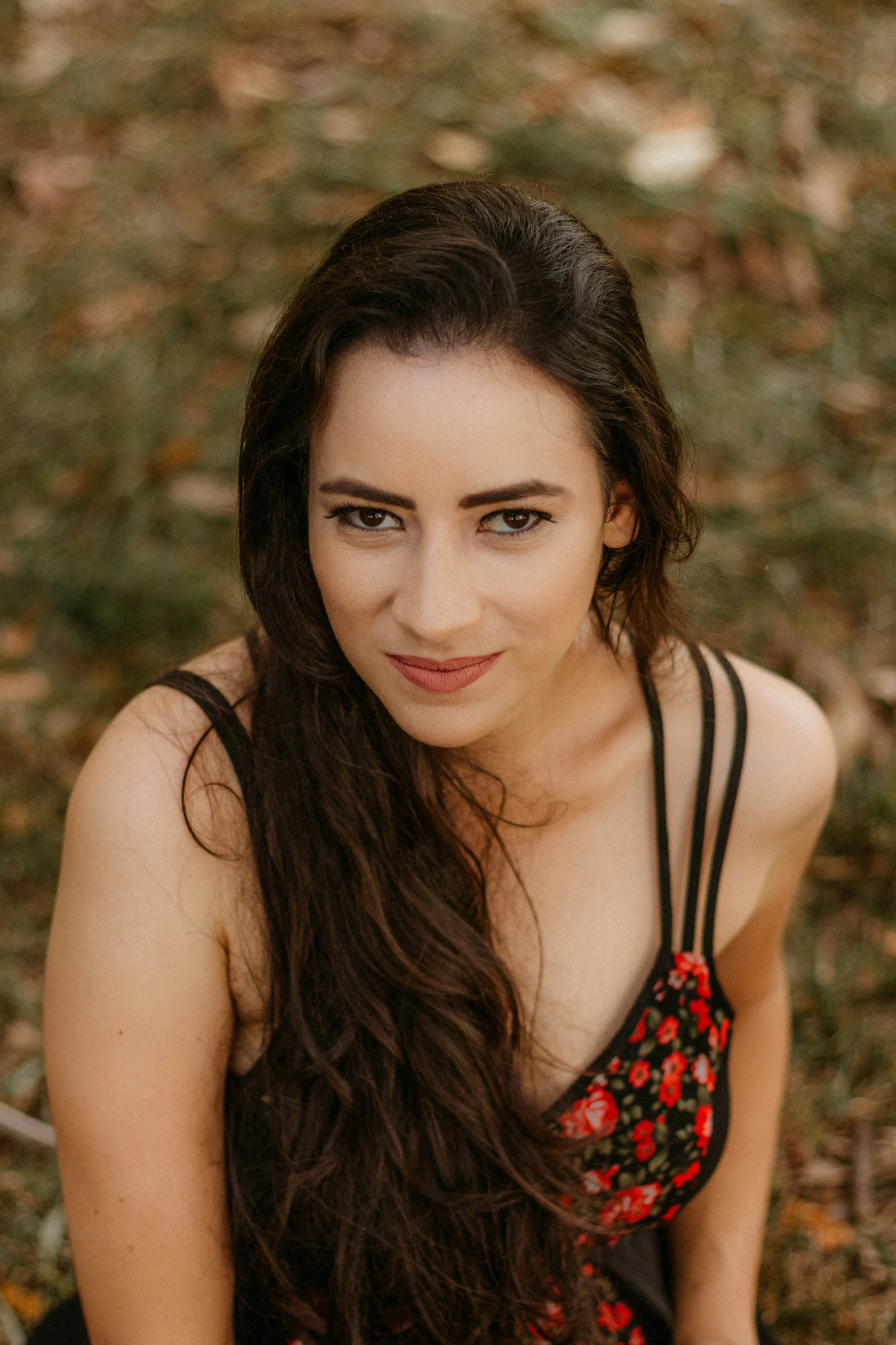 a  wearing a black tank top sitting in the grass