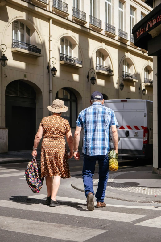 a couple walks across a street together