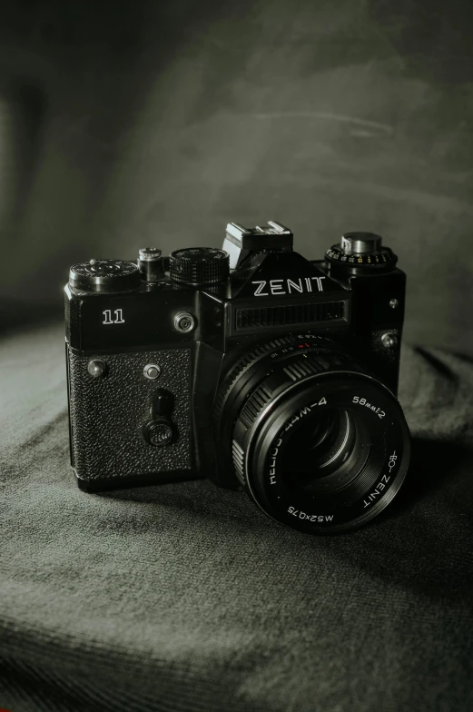 a camera is sitting on the bed with a black background