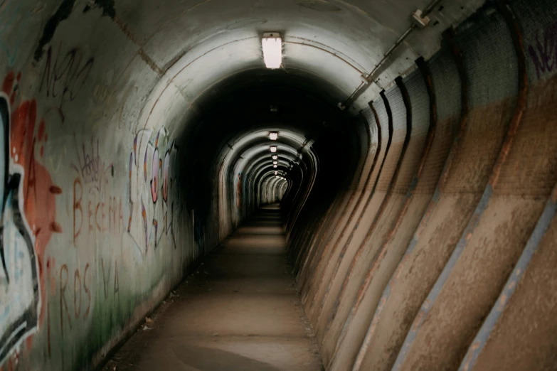 there are a very long tunnel with graffiti on it