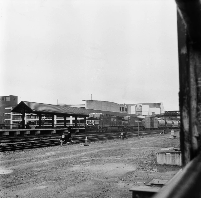 black and white pograph of train cars at train station