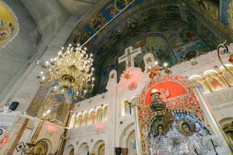 a big ornate building with paintings and chandelier