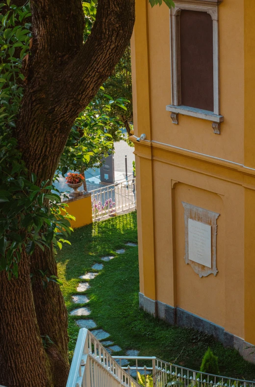 the yellow building is next to a big tree